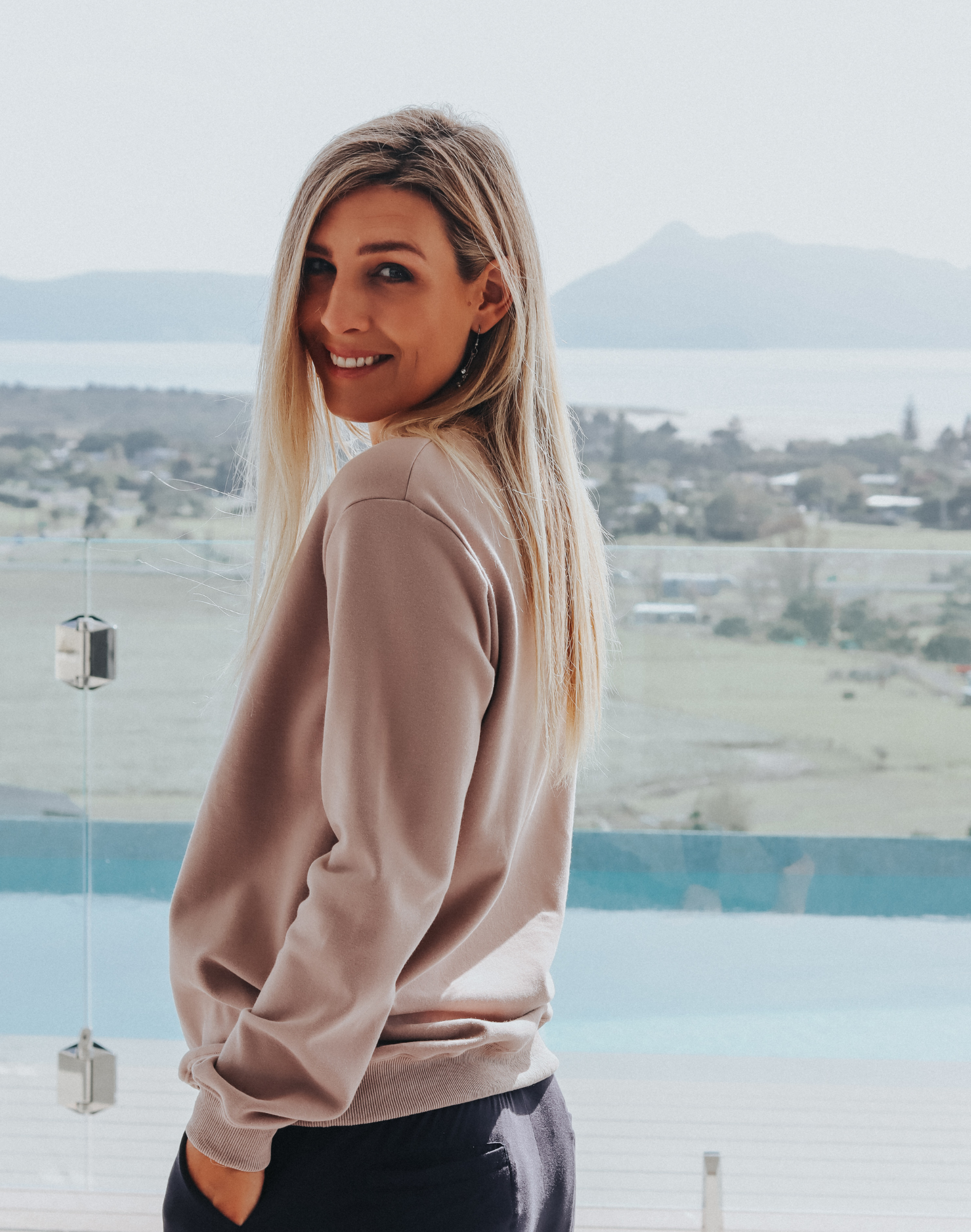 Side view of grey women's crew sweatshirt